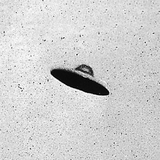 Black-and-white photo showing a disc-shaped object with a shadowed underside, floating in a blank sky—an iconic image from the UFO craze.