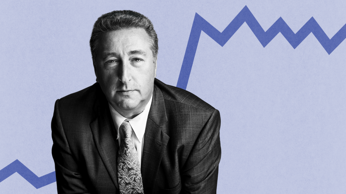 Barry Ritholtz, a man in a suit and tie, stands confidently before a blue zigzag line on a light backdrop.