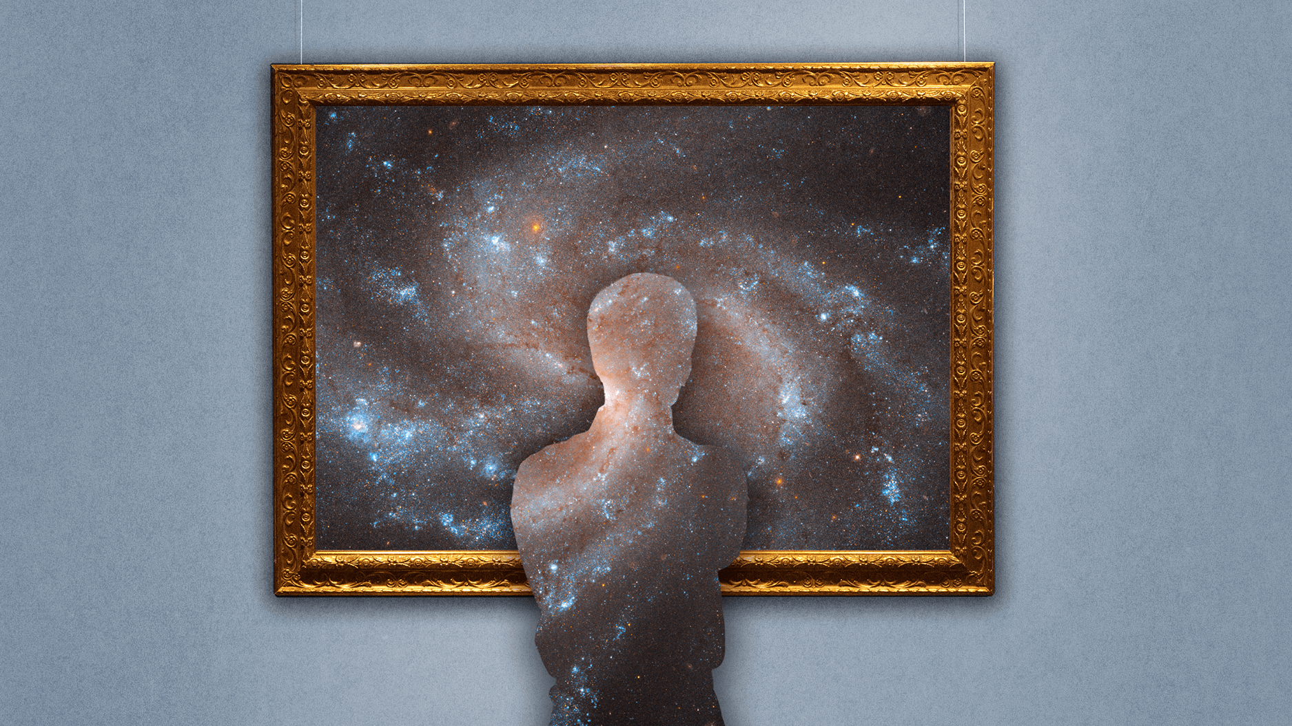 A silhouette of a person blends into an image of a galaxy displayed in a gold ornate frame on a gray wall.