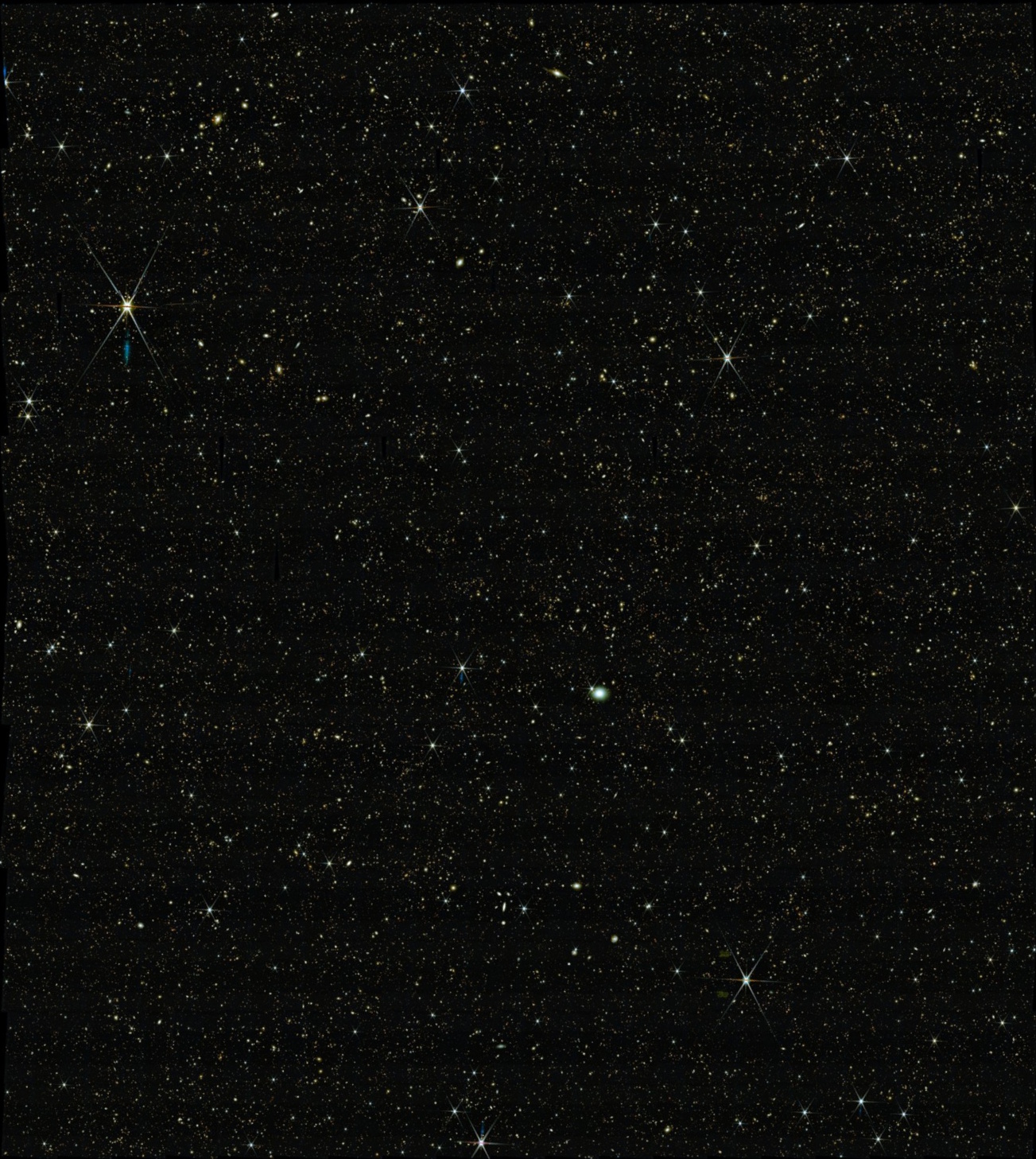 A dense field of stars scattered across a dark night sky, with some stars&mdash;and distant galaxies&mdash;appearing brighter and larger than others, as revealed by JWST science.