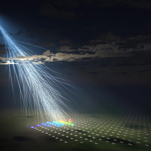 An illustration shows a cosmic ray entering Earth’s atmosphere, creating a cascade of secondary particles—some of the highest energy particles astronomers study—detected by an array of sensors on the ground.