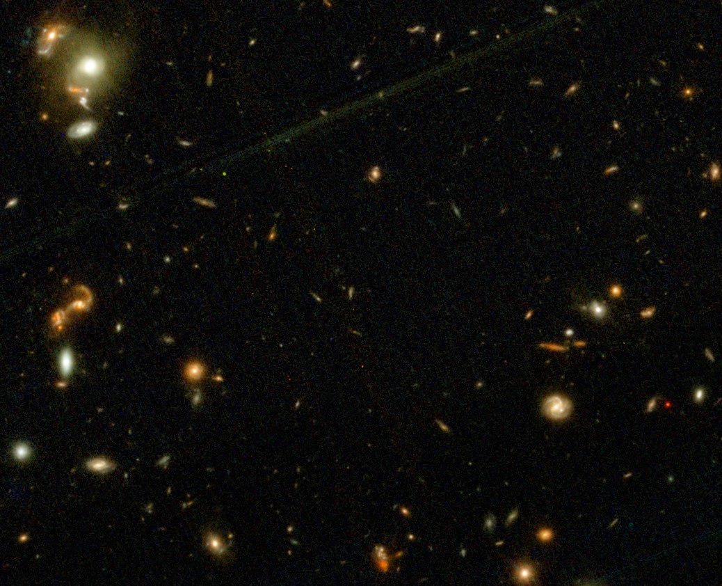 A view of deep space captured by JWST shows numerous distant galaxies of various sizes and colors scattered across a dark background, highlighting the wonders of science.