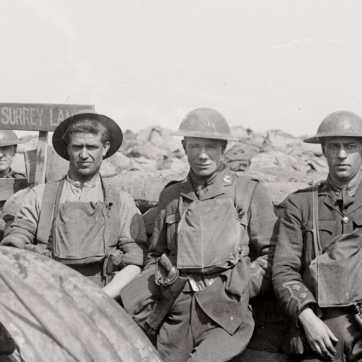 Five World War I soldiers in uniform stand and sit near sandbags in a trench, with a sign reading "Surrey Lane" visible in the background—evoking camaraderie amid the Ring of Fire on the front lines.