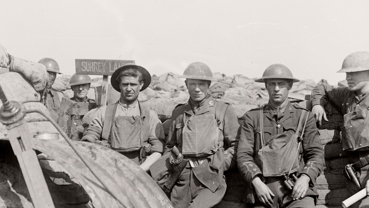Five World War I soldiers in uniform stand and sit near sandbags in a trench, with a sign reading "Surrey Lane" visible in the background—evoking camaraderie amid the Ring of Fire on the front lines.