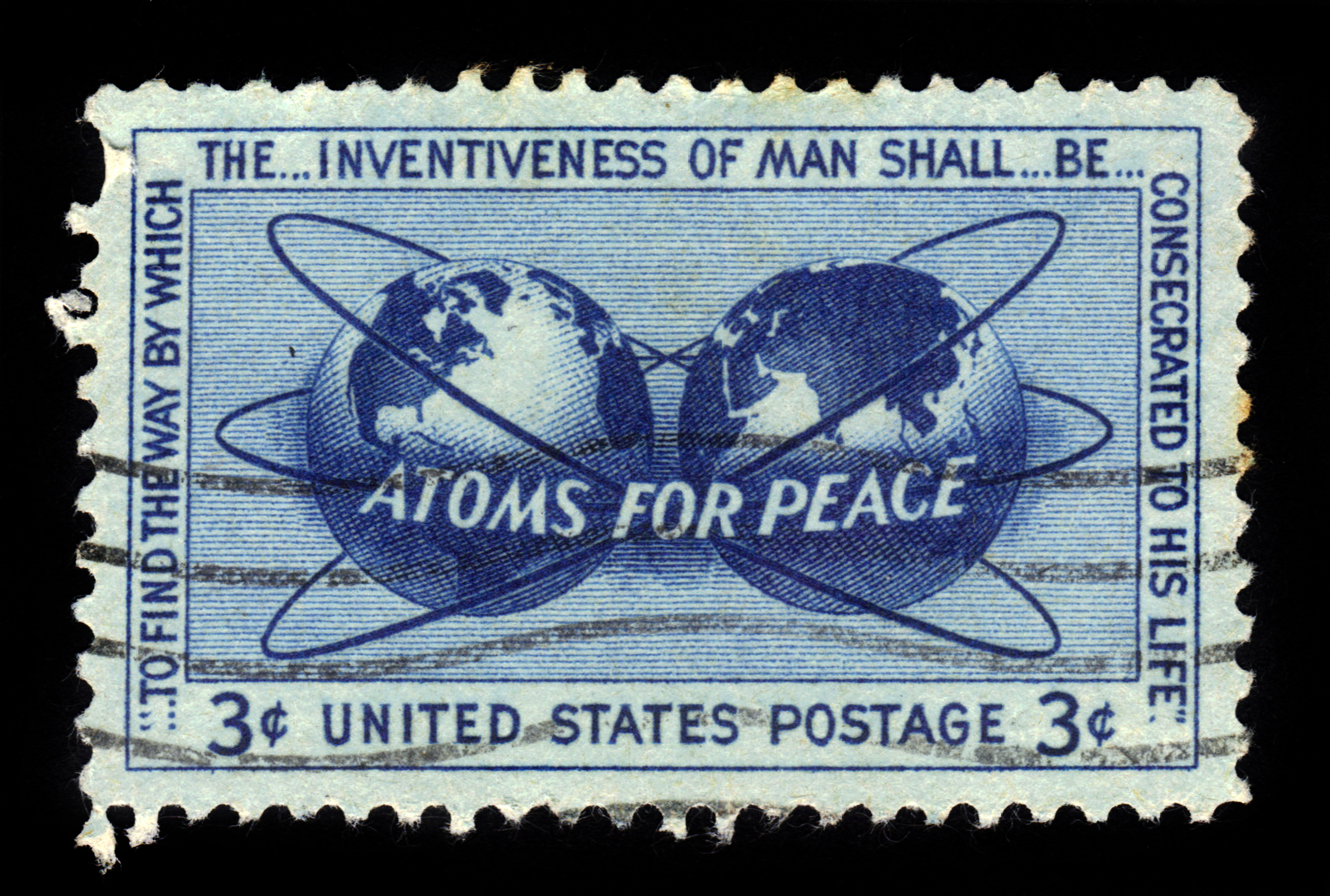 A blue 3-cent US postage stamp featuring two globes, atomic orbits, and the words &ldquo;ATOMS FOR PEACE,&rdquo; with additional text promoting the peaceful use of atomic energy.