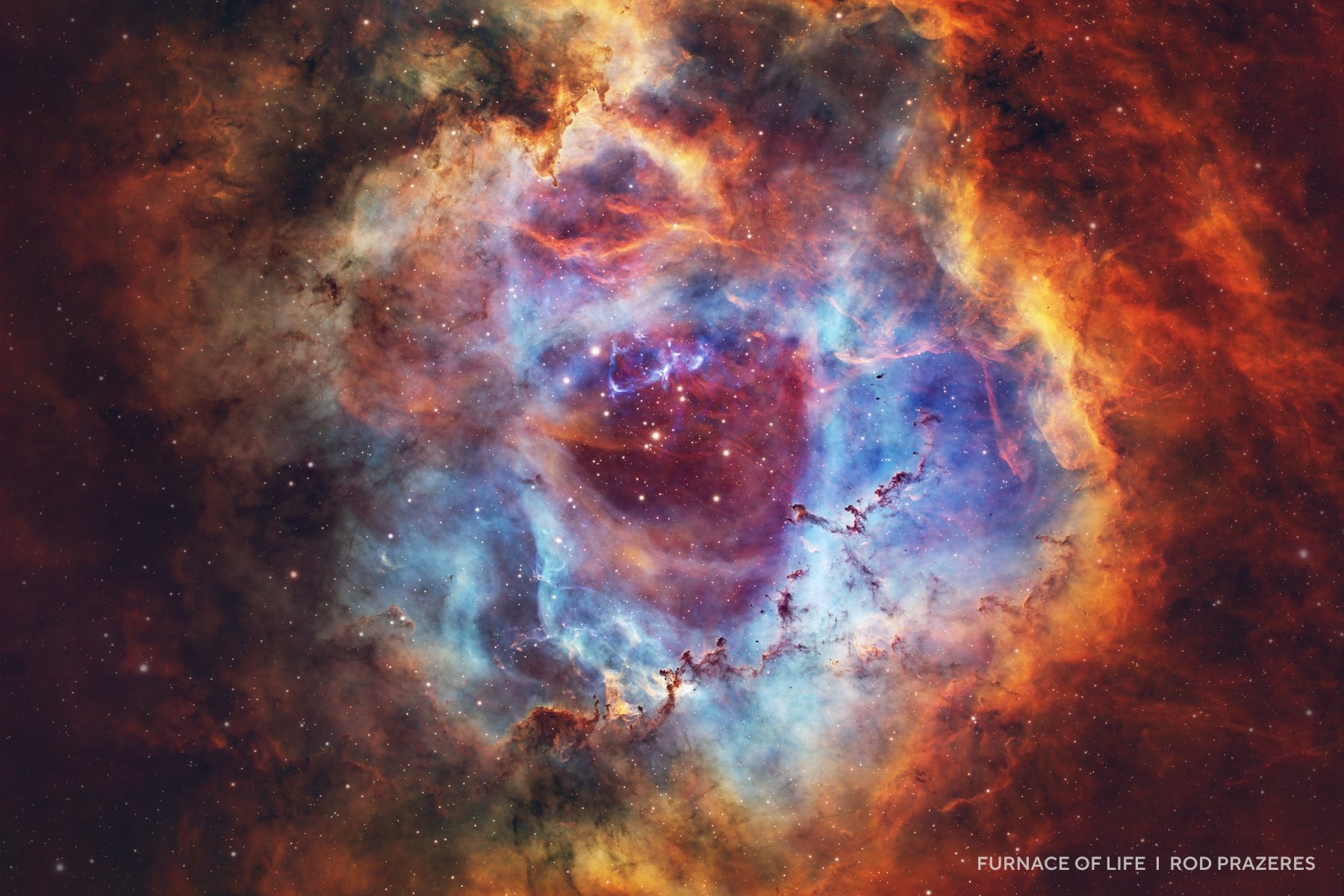 Colorful nebula with blue, orange, and red clouds of gas and dust, featuring bright stars scattered throughout the center&mdash;a stunning example of cosmic beauty captured in 2025 night sky images.