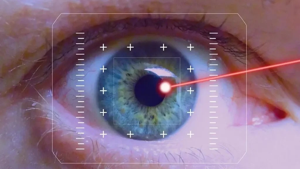 Close-up of a human eye with a digital interface overlay and a red laser beam targeting the pupil, illustrating the science of LASIK and advanced vision correction technology.