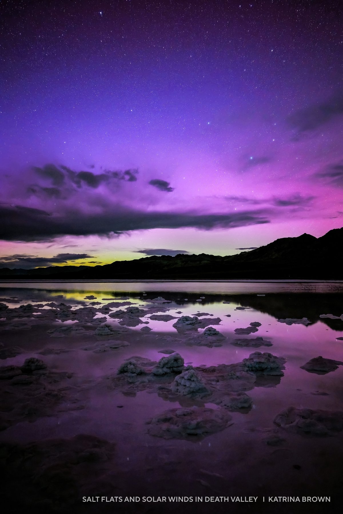 Salt flats in Death Valley with scattered salt formations reflect a purple and pink night sky filled with stars and clouds, capturing the magic seen in 2025 night sky images.
