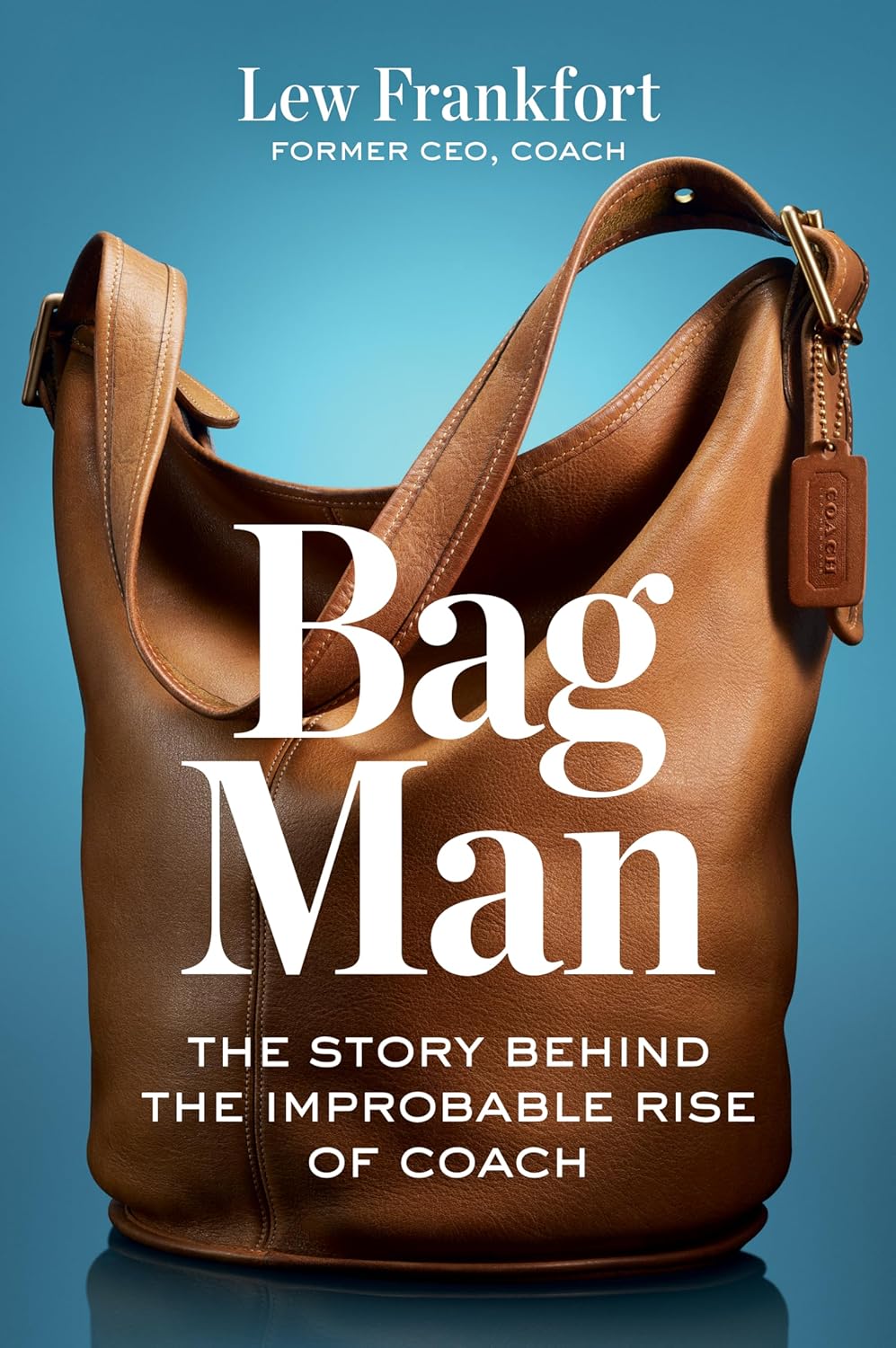 A brown leather Coach handbag against a blue background, with the book title "Bag Man" and author Lew Frankfort's name, highlighting the story behind Coach's rise.