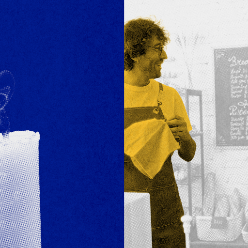 A white candle with smoke rising from its wick is shown on the left; on the right, two men wearing aprons stand talking in front of a café menu.