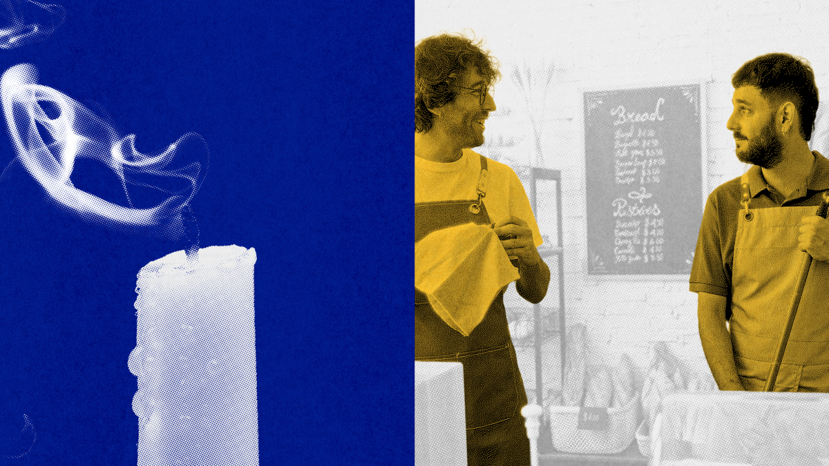 A white candle with smoke rising from its wick is shown on the left; on the right, two men wearing aprons stand talking in front of a café menu.