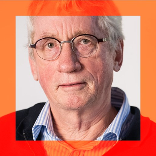 An older man with short gray hair and glasses, wearing a blue striped shirt and a red sweater, is framed by an orange translucent square overlay.