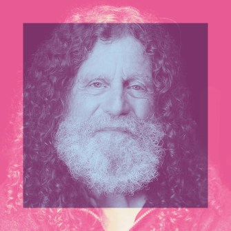 Elderly man with long curly hair and a full white beard, centered in a pink-tinted square frame with a pink background.