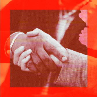 Two people wearing business attire shake hands, photographed close-up, with a red filter overlaying the image.