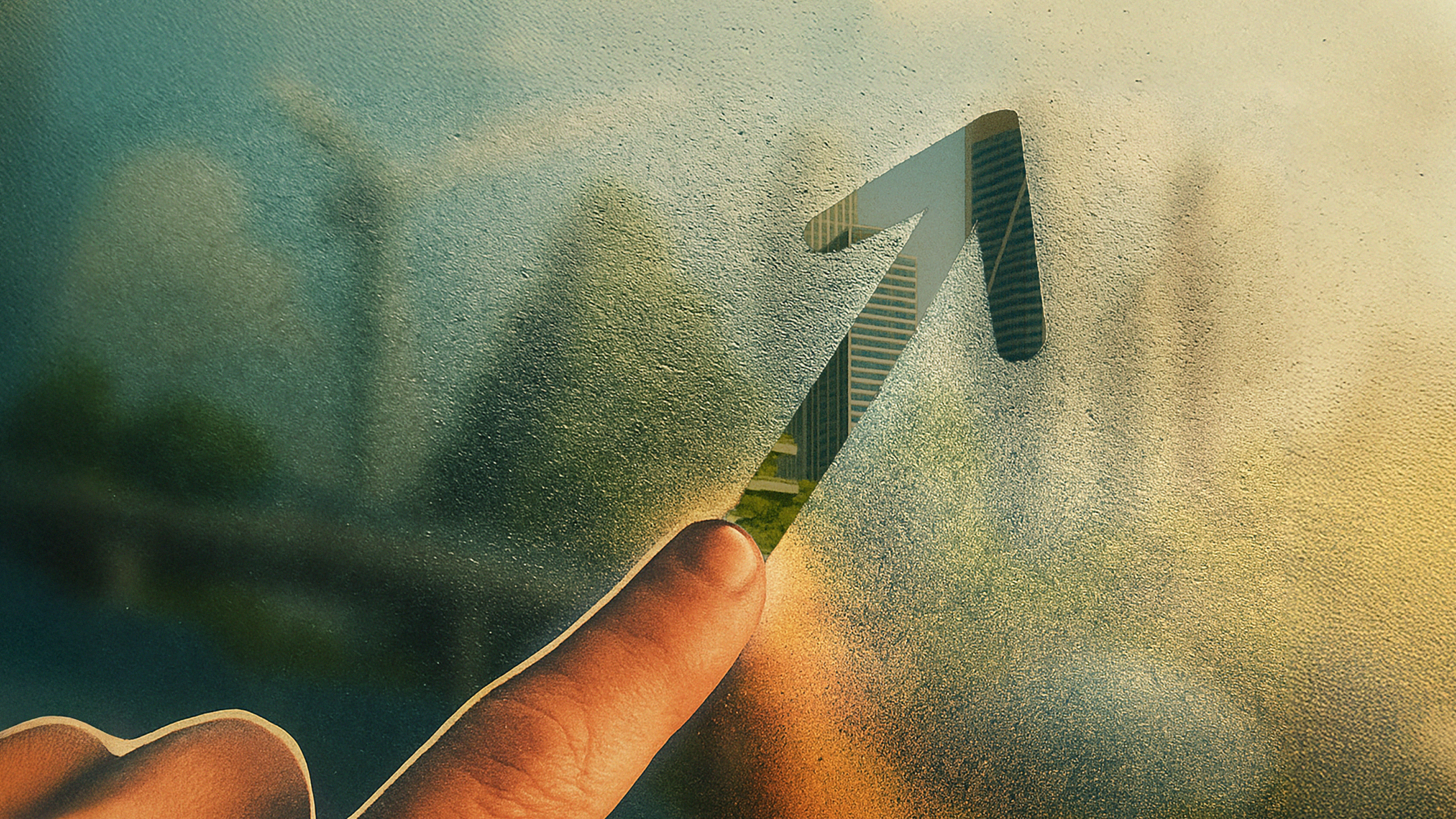 A finger draws an upward-pointing arrow on a foggy window, with buildings and greenery visible through the glass.