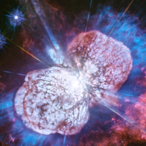 A detailed image of the Eta Carinae star system could trick science headlines with its bright, colorful clouds of gas and dust in blue, red, and purple hues swirling around a luminous central region.