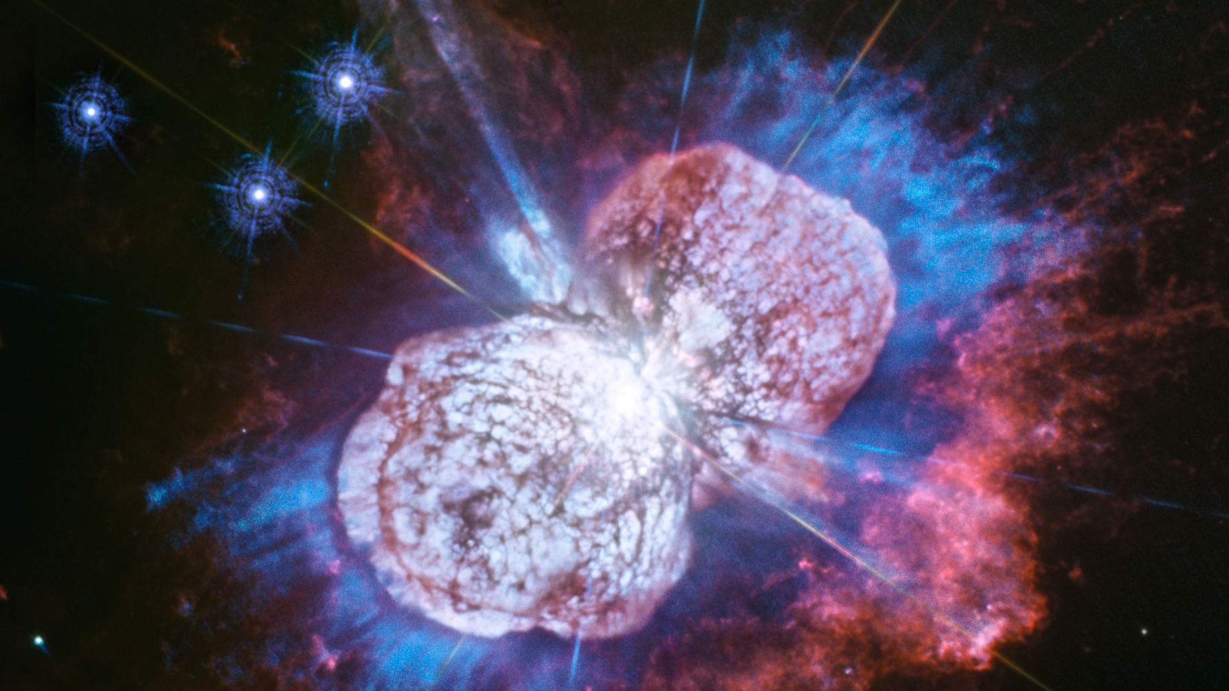 A detailed image of the Eta Carinae star system could trick science headlines with its bright, colorful clouds of gas and dust in blue, red, and purple hues swirling around a luminous central region.