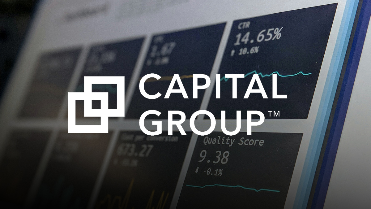 Capital Group logo over a blurred background of data charts and analytics displayed on a screen.