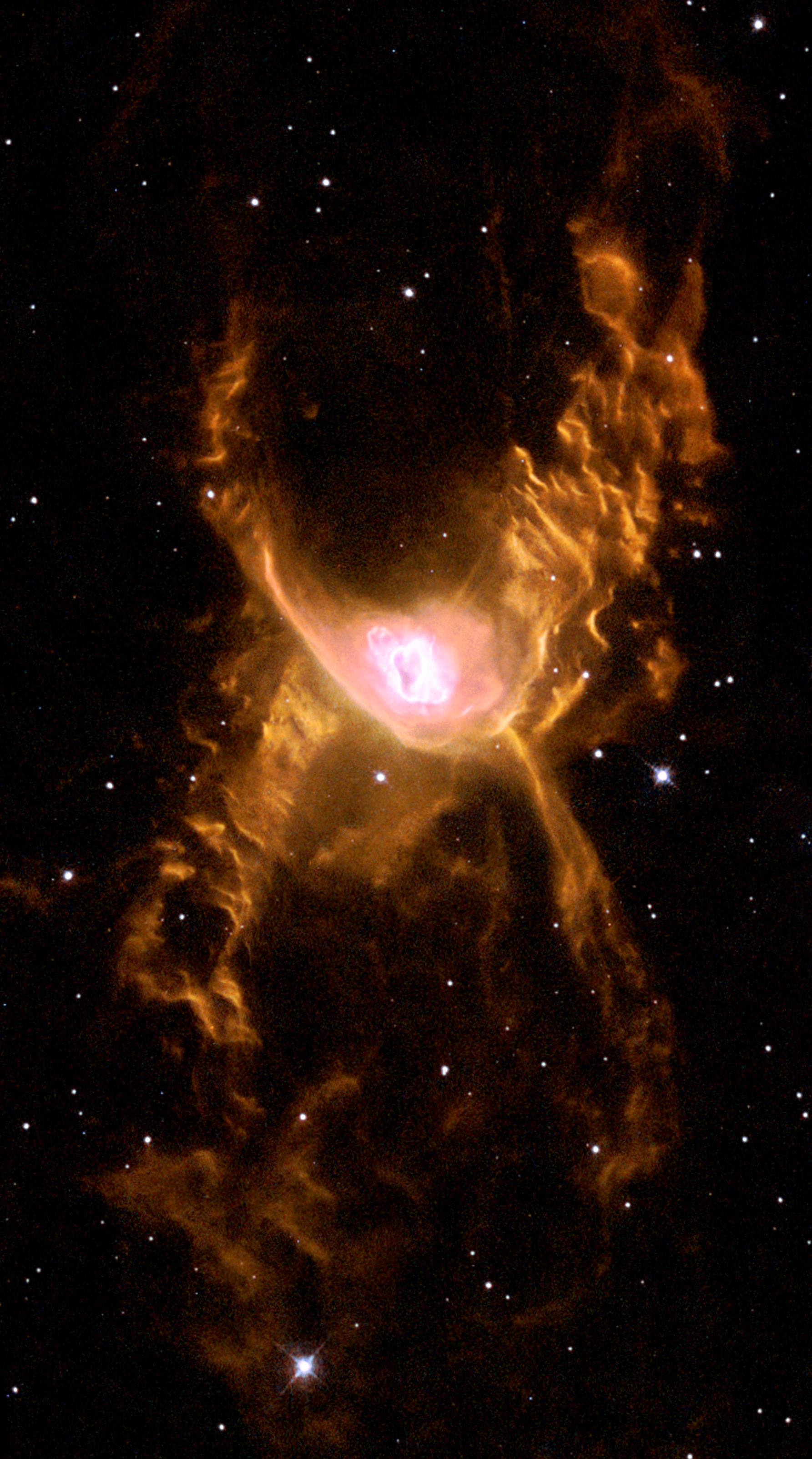 A glowing, orange-hued nebula with a bright center and wispy outer clouds, set against a dark background dotted with stars.