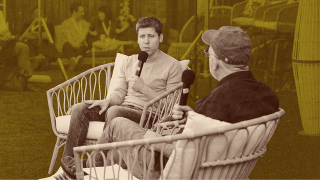 Two people sit in wicker chairs outdoors, holding microphones and having a conversation about energy abundance. Other people are visible in the blurred background.