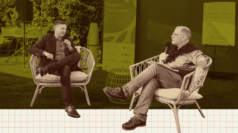 Two men sit on outdoor chairs holding microphones, engaged in conversation at an event. A conference sign is visible in the background.