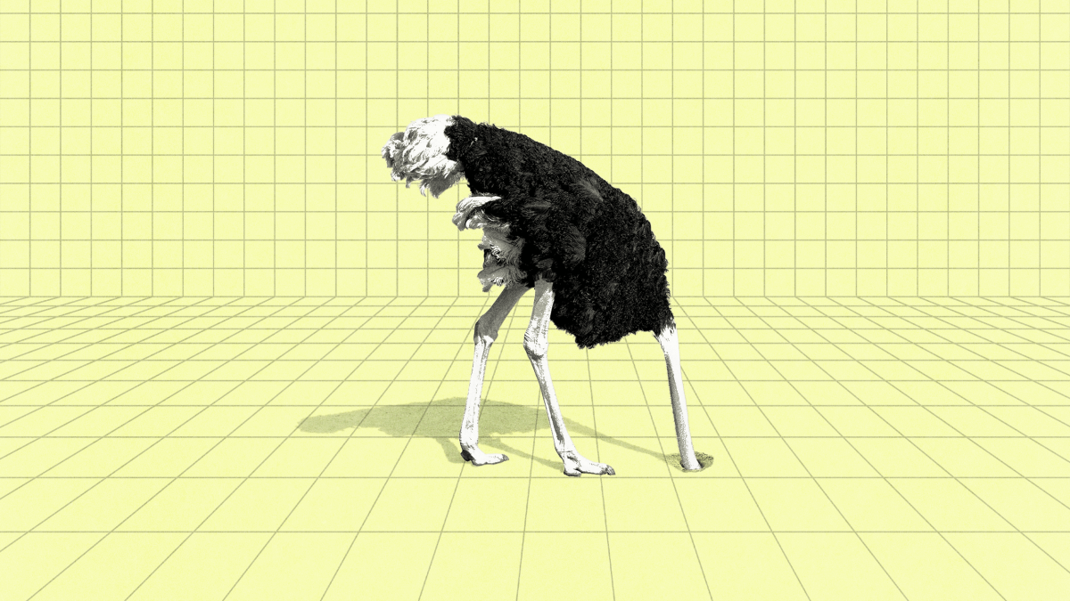 An ostrich with its head buried in a grid-patterned yellow floor against a matching grid-patterned wall.
