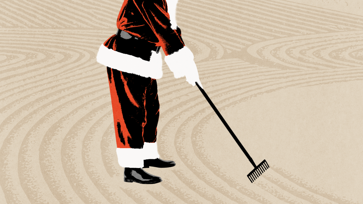 Person wearing a Santa Claus suit rakes sand in a purposeful pattern, resembling a Zen garden, against a beige background.