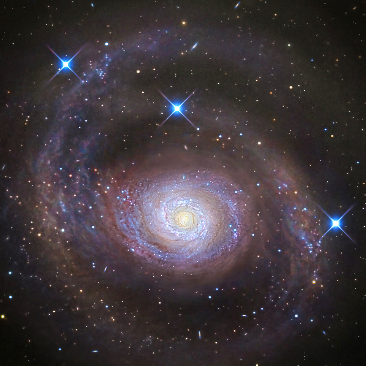 A spiral galaxy with a bright core and swirling arms drifts near a starless gas cloud, surrounded by stars and deep space.