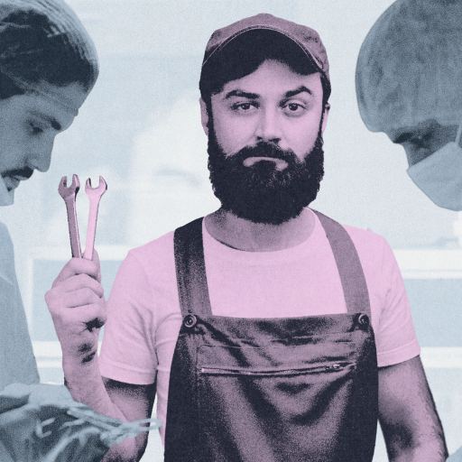 A man in overalls, an example of epistemic trespassing, holds wrenches while standing between surgeons in scrubs and masks performing surgery.