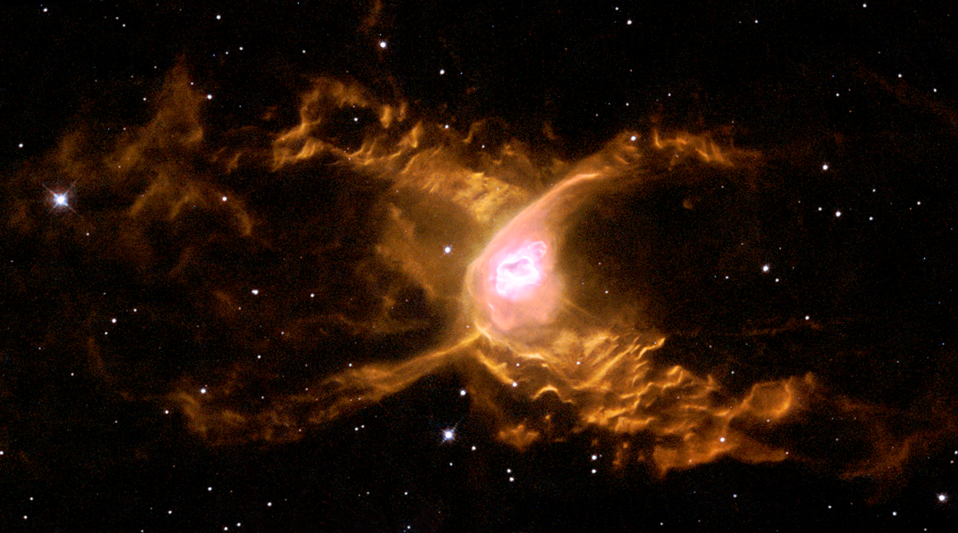 An orange-hued nebula with bright, glowing filaments and a luminous center is surrounded by dark space and distant stars&mdash;a stunning JWST reveal showcasing the wonders of our universe.