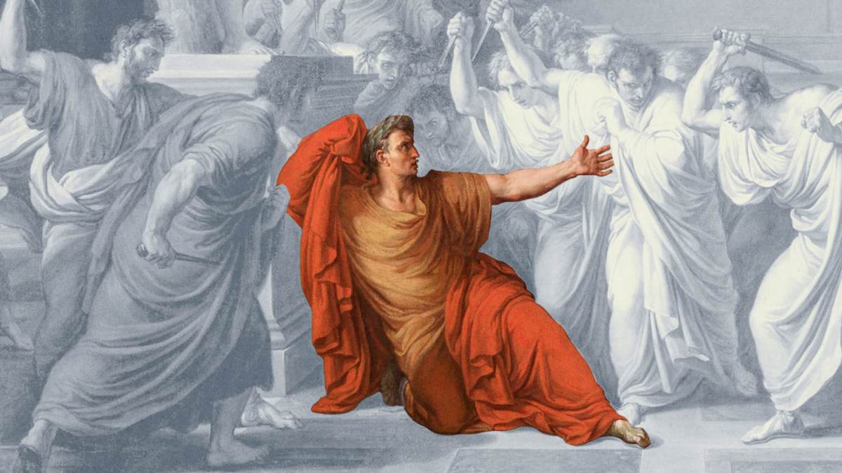 A man in a red and gold robe, resembling Julius Caesar, kneels on the ground, reaching out as several men in white robes with raised weapons surround him.