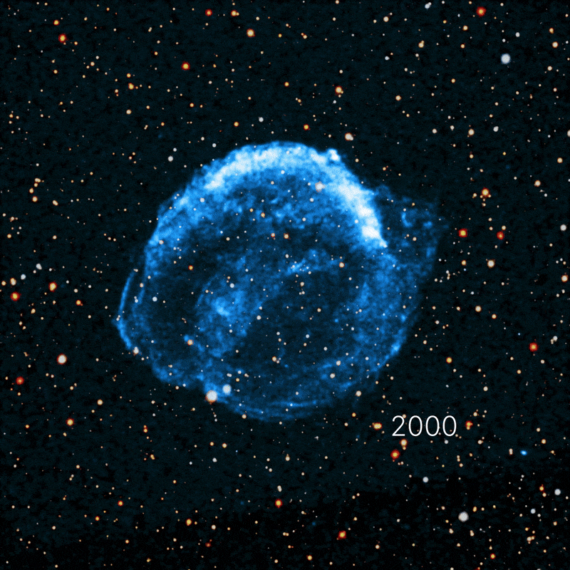 A glowing blue supernova remnant, observed by NASA Chandra, appears against a star-filled black background, with "2000." written in white text at the lower right of the remnant, marking 25 years since Kepler's supernova began to expand.