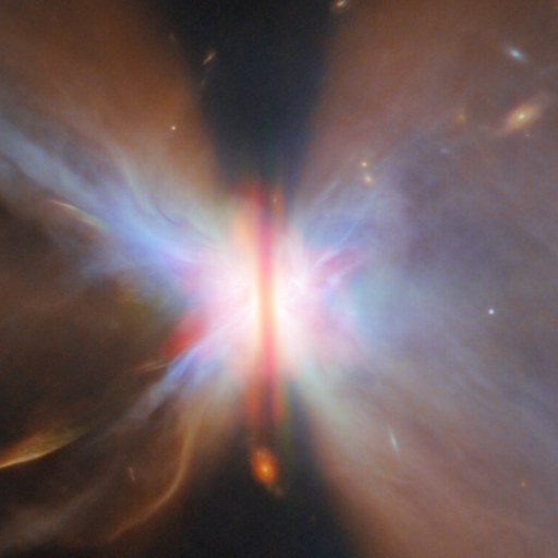 A colorful nebula with a bright center and symmetrical, wing-like clouds of gas and dust extends outward in space, as seen in a JWST reveal that uncovers stars and galaxies in the universe beyond.