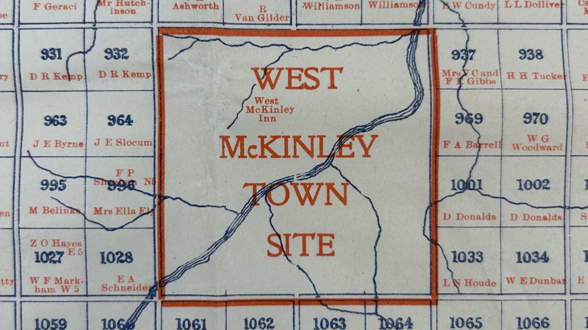 A section of a map labeled "West McKinley Town Site" with surrounding property names and numbers in blue and orange text.
