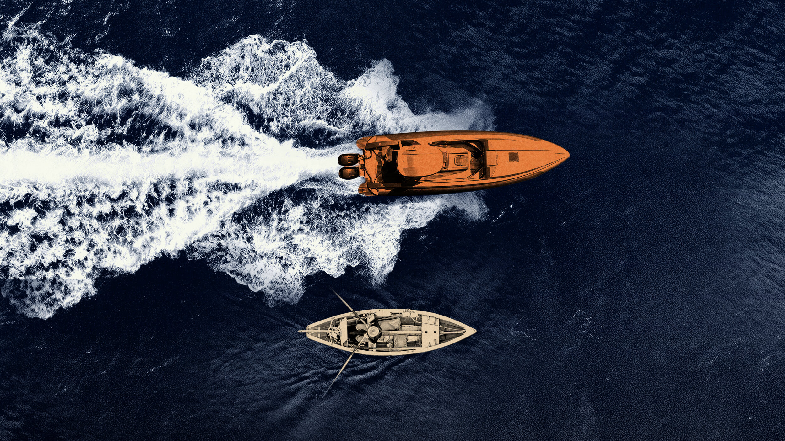 Aerial view of a speeding motorboat leaving a wake near a slower rowboat on dark blue water.