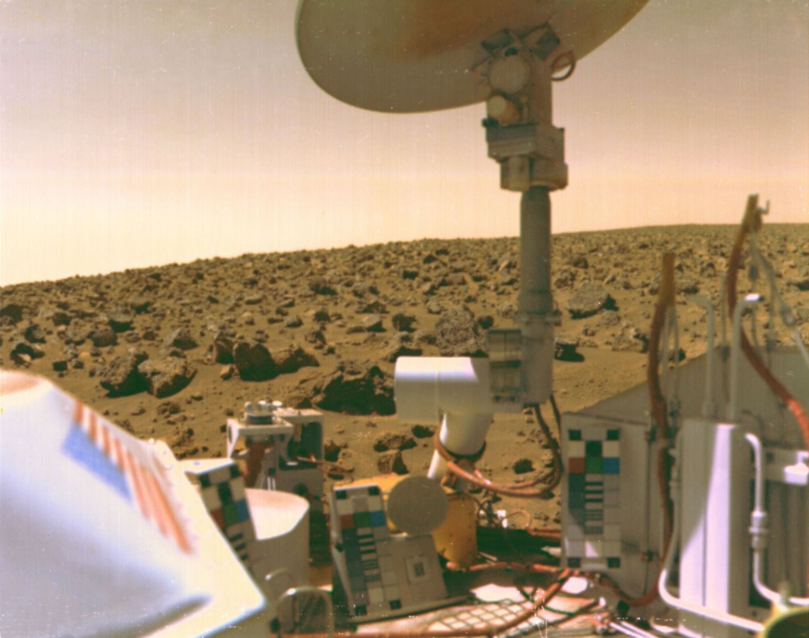 Martian surface with rocky terrain lies behind the Viking lander equipment and instruments, including a large satellite dish, under a dusty sky&mdash;highlighting the 7 hurdles in claims of extraterrestrial life.