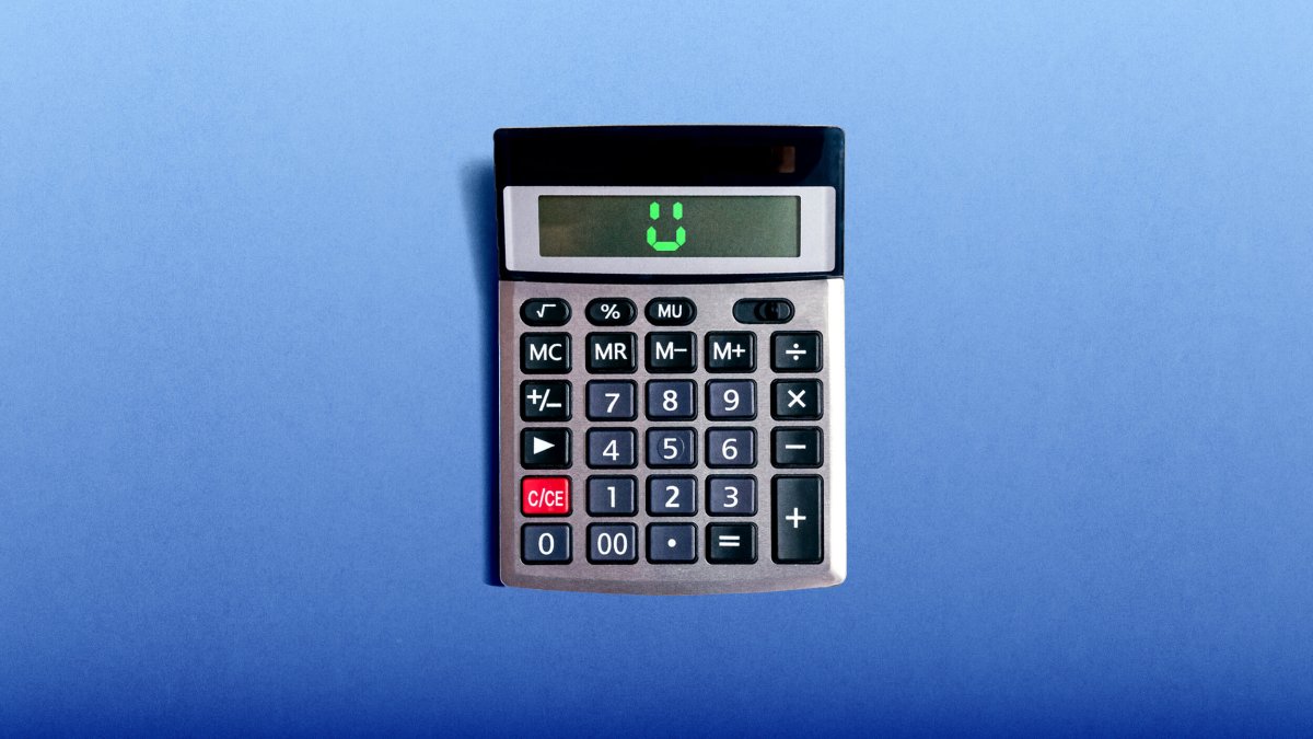 A calculator on a blue surface displays a smiling face on its screen.