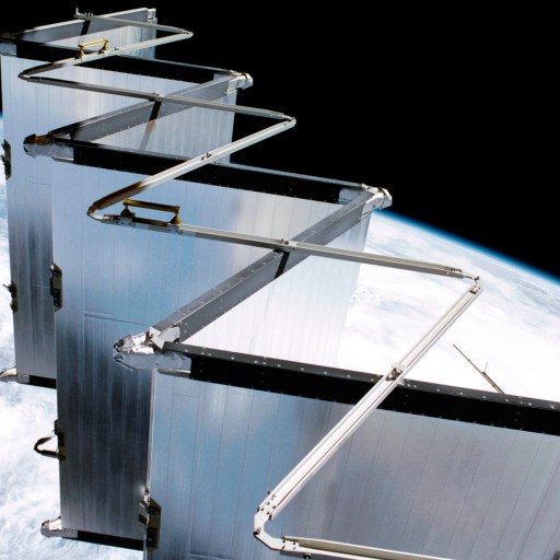 A satellite with extended accordion-like solar panels or reflectors, possibly supporting AI data centers in space, orbits above Earth, with the planet’s surface visible in the background.