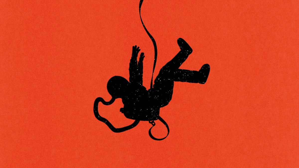 A black silhouette of an astronaut is suspended upside down by a cord against a solid red background.