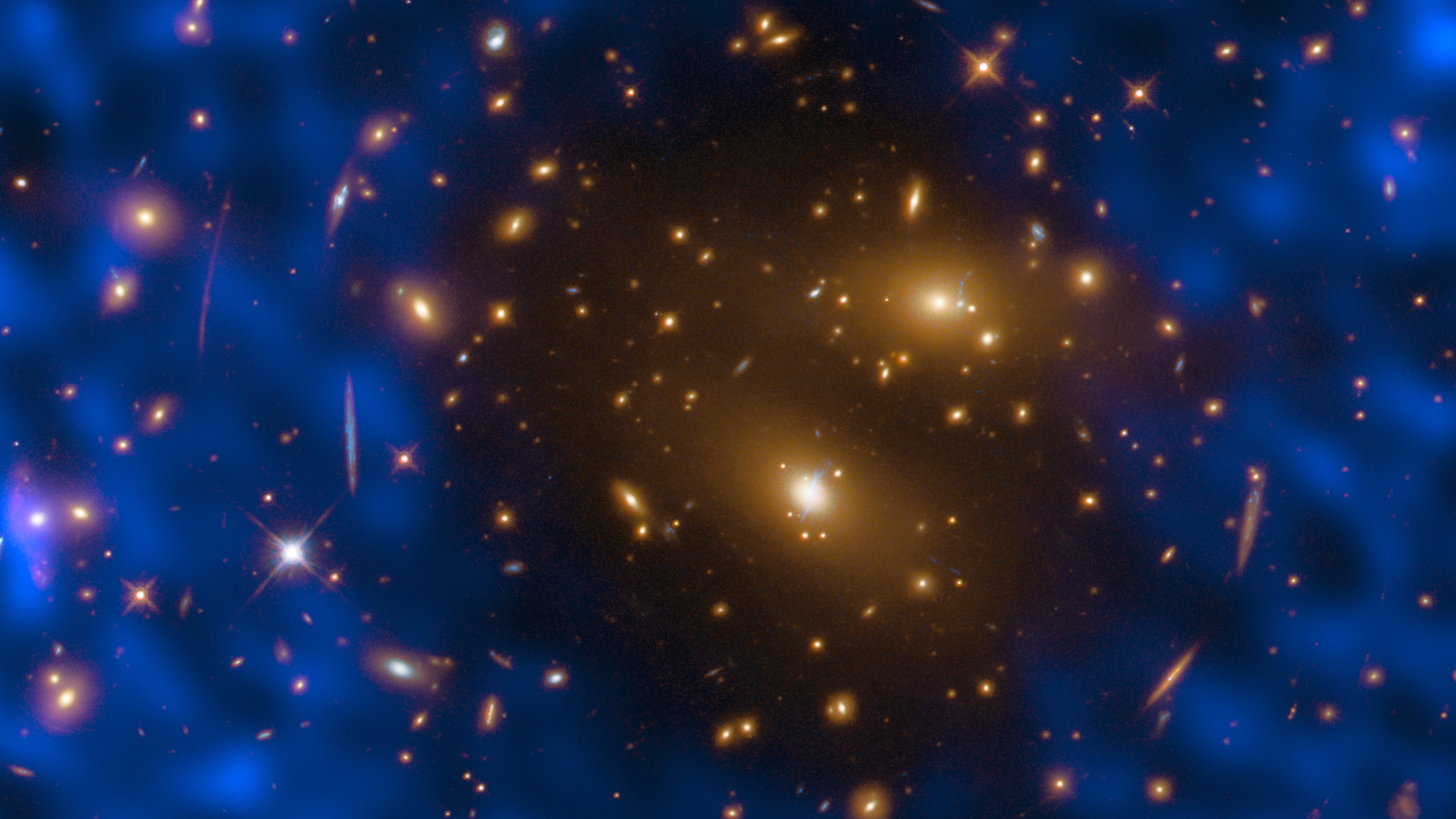 Image of a galaxy cluster with bright yellow galaxies at the center, surrounded by blue regions representing dark matter in deep space—a striking view often used for dark matter cosmic test MOND studies.