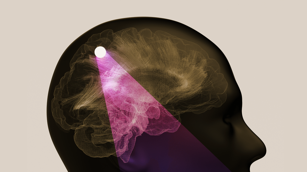 A digital illustration of a human head in profile showing a highlighted section of the brain with a bright light beam focused on a specific point inside the brain.