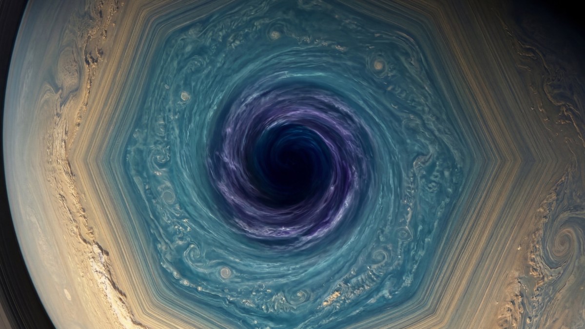 A hexagonal storm formation with a dark central vortex on a planet’s surface, showing swirling blue and tan cloud patterns.