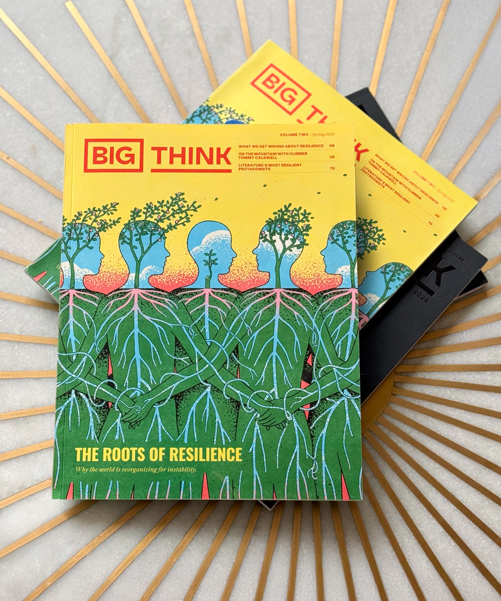 A stack of Big Think magazines, with the top cover featuring illustrated figures with plants as heads and roots connecting their bodies, titled "The Roots of Resilience.