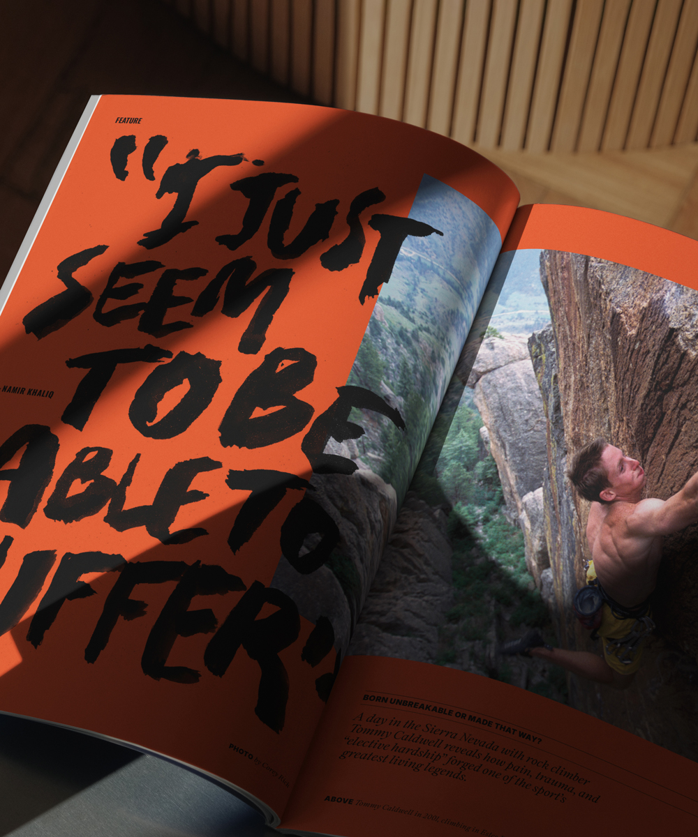 An open magazine shows a large quote in bold black letters on an orange page and a photo of a person rock climbing on a steep cliff on the opposite page.